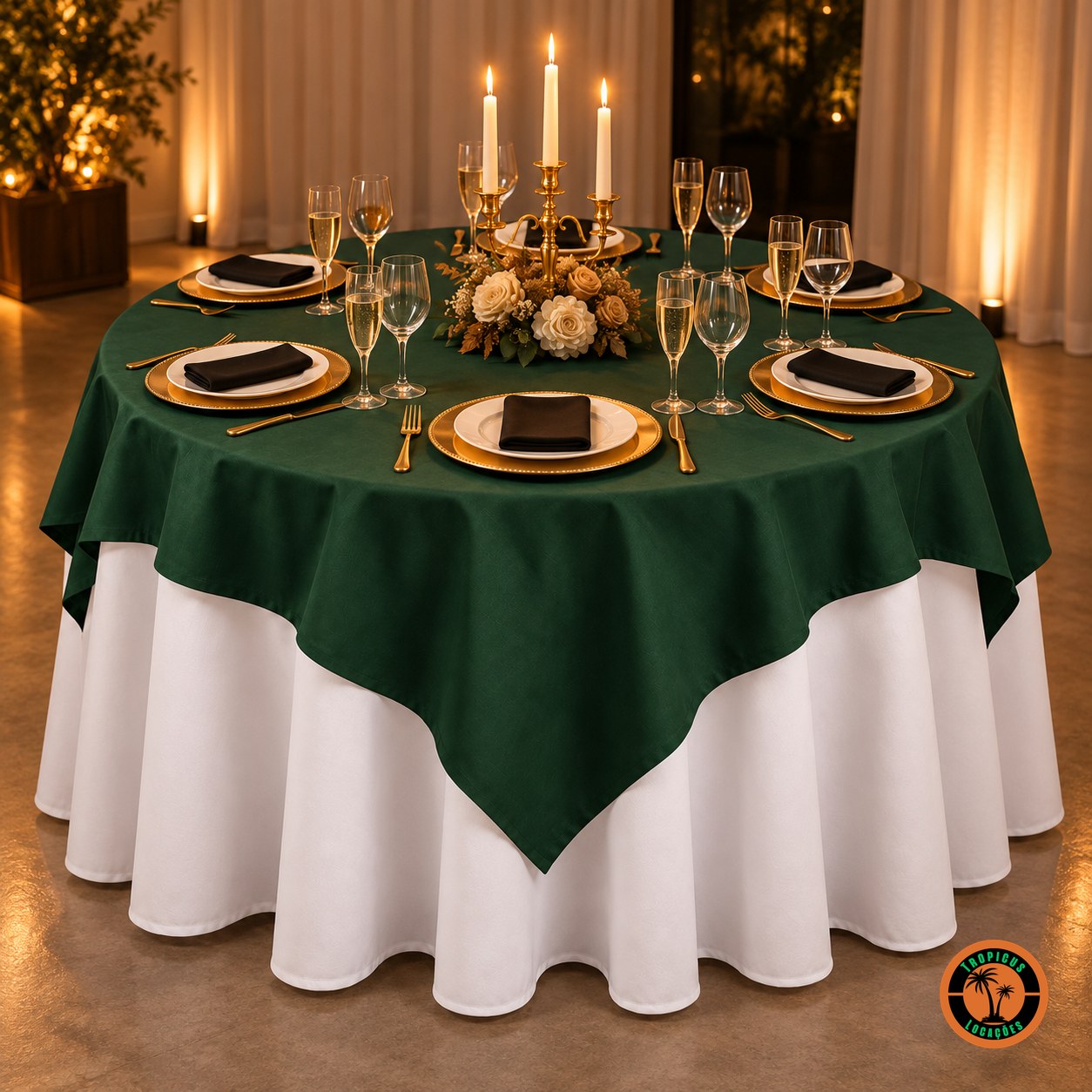 Mesa redonda com cobre-mancha verde-escuro sobre toalha branca, candelabro com velas e sousplats dourados